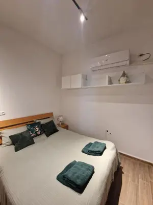 a bedroom with a bed with two green towels on it at Apartment in Sunny Fort in Sunny Beach