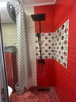 a red shower in a bathroom with a red wall at Apartment in Sunny Fort in Sunny Beach