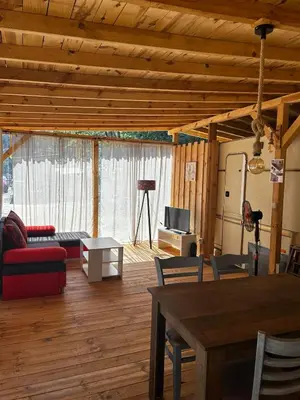 a living room with a couch and a table at Каравана Рубин in Chernomorets