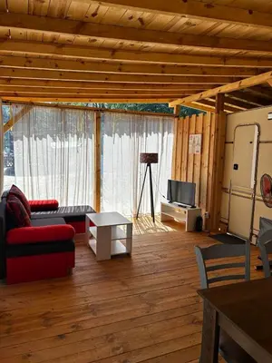 a living room with a couch and a tv at Каравана Рубин in Chernomorets