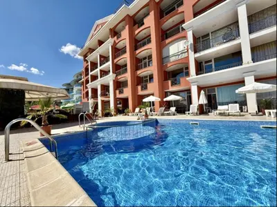 a large swimming pool in front of a building at Carina Beach - Menada Apartments in Sunny Beach