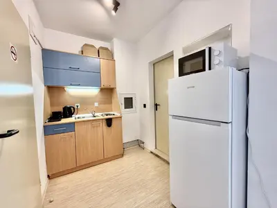 a kitchen with a refrigerator and a sink at Carina Beach - Menada Apartments in Sunny Beach