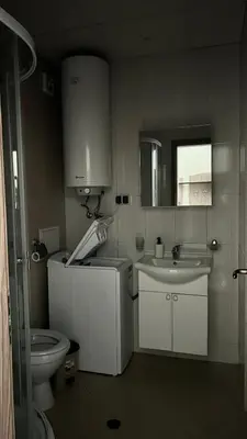 a bathroom with a toilet and a sink and a mirror at Sunny Beach Fort Noks Orchid Apartment in Sunny Beach