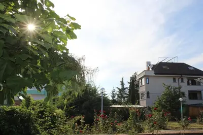 a white building with the sun in the sky at Villa Elmar in Kiten