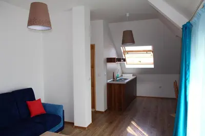 a living room with a blue couch and a sink at Villa Elmar in Kiten