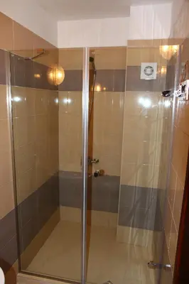 a shower with a glass door in a bathroom at Villa Elmar in Kiten