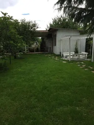 a yard with a house with a picnic table and benches at Villa Elmar in Kiten