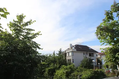 a white house with trees in front of it at Villa Elmar in Kiten
