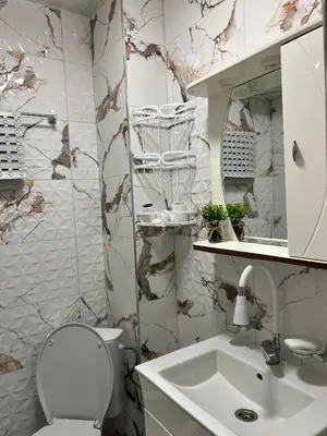 a bathroom with a toilet and a sink at Апартамент Боги in Burgas City