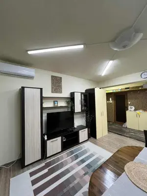 a living room with a flat screen tv on the wall at Апартамент Боги in Burgas City