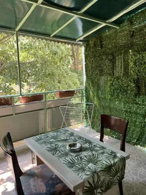 a table and two chairs on a patio at Апартамент Боги in Burgas City
