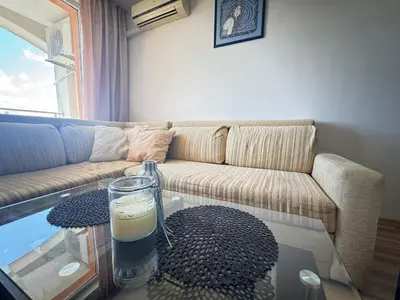 a living room with a couch and a glass table at Линоляни in Pomorie