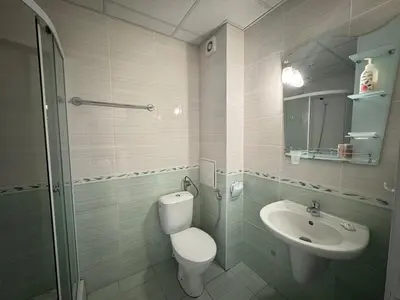 a bathroom with a toilet and a sink at Линоляни in Pomorie