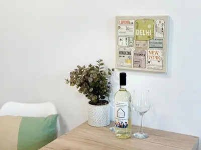 a bottle of wine and a glass on a table at Sweet tiny house-central studio in Varna City