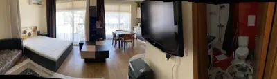 a living room with a bed and a tv in a room at Luxury Studio B02 SB in Sunny Beach