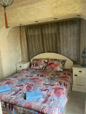 a bedroom with a large bed in a room at Къща за гости DOSH in Sozopol