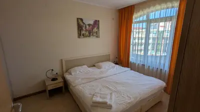 a bedroom with a white bed and a window at 1BD Apartment in Royal Sun Complex, Sunny Beach by Flat Mаnager in Sunny Beach