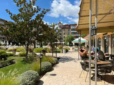 a person taking a picture of a patio with a table at 1BD Apartment in Royal Sun Complex, Sunny Beach by Flat Mаnager in Sunny Beach