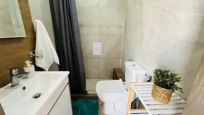 a bathroom with a white toilet and a sink at JADORE Secret Garden Panoramic Studio in Sunny Beach