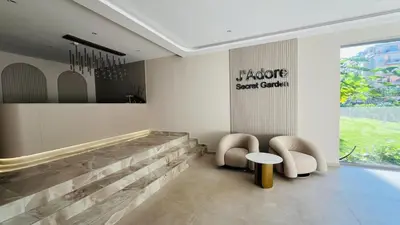 a lobby with two chairs and a bench and a table at JADORE Secret Garden Panoramic Studio in Sunny Beach