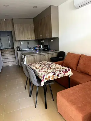 a living room with a table and a couch at Central 1BR Apartment Near Cathedral in Varna City