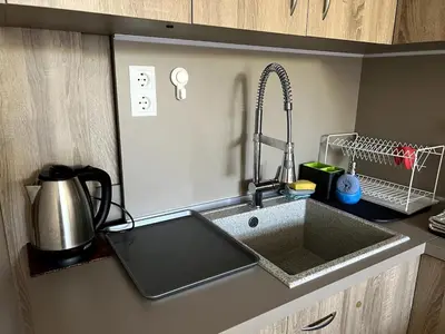 a kitchen counter with a sink and a mixer at Central 1BR Apartment Near Cathedral in Varna City