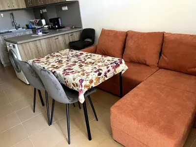 a living room with a table and a couch at Central 1BR Apartment Near Cathedral in Varna City