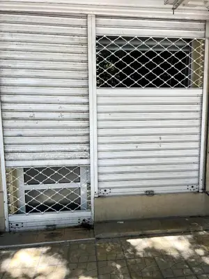 a metal garage door with a gate on it at Central 1BR Apartment Near Cathedral in Varna City