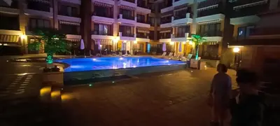 a swimming pool in the middle of a building at night at Boulevard Sea Residenz in Sunny Beach