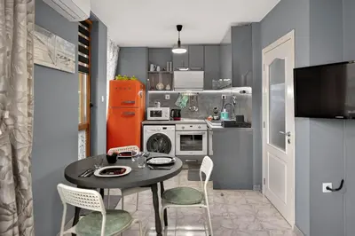 a small kitchen with a black table and chairs at Dany's Apartments in Varna City