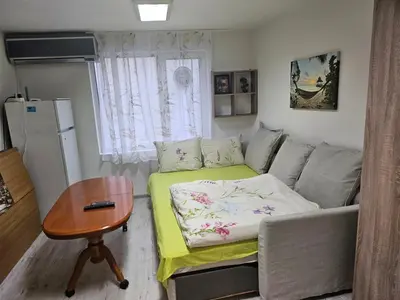 a small living room with a couch and a table at Гарсониера в центъра на град Бургас l in Burgas City