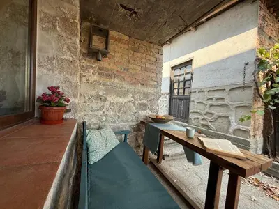 an outdoor patio with a table and a bench at Villa Filistrina in Yasna Polyana