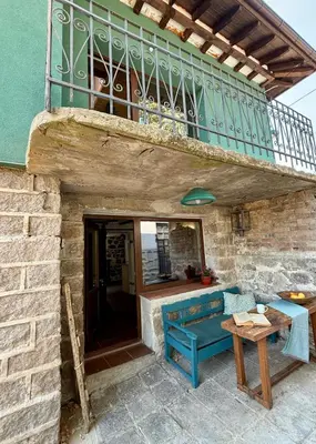 a blue bench sitting on a patio under a balcony at Villa Filistrina in Yasna Polyana