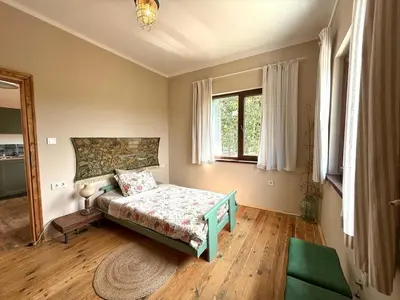 a bedroom with a bed and a window at Villa Filistrina in Yasna Polyana
