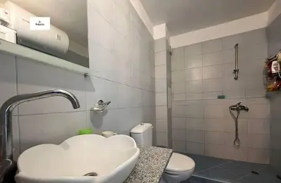 a bathroom with a sink and a toilet at Двустаен апартамент с морска панорама в Blue Bay Palace in Pomorie