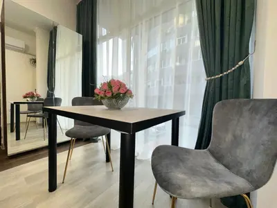a dining room with a table and two chairs at Апартамент за нощувки и отдих in Burgas City