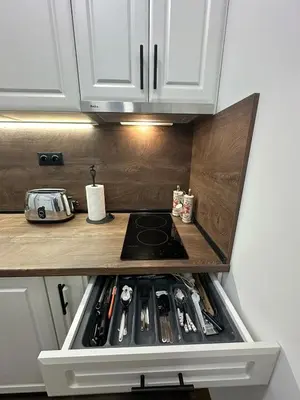 a kitchen with a stove top oven in a kitchen at Апартамент за нощувки и отдих in Burgas City