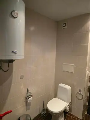 a bathroom with a white toilet in a room at Sarafovo ATLANTIS 58 in Burgas City