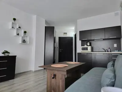 a living room with a couch and a table at Sarafovo ATLANTIS 58 in Burgas City