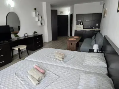 a bedroom with a large bed with two towels on it at Sarafovo ATLANTIS 58 in Burgas City