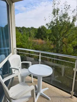 two white chairs and a table on a balcony at Sarafovo ATLANTIS 58 in Burgas City