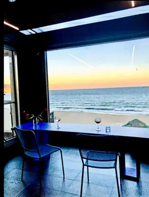 a table and chairs with a view of the ocean at Seafront Luxury Studio with Panoramic Sea View, Sunny Beach in Sunny Beach
