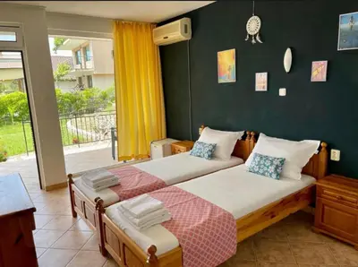 a bedroom with two beds and a window with a view at Serenity Hill-Bulharsko U Nás in Sveti Vlas