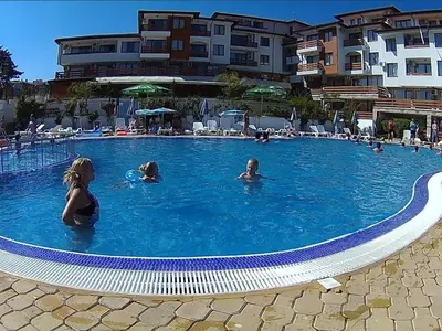 a group of people swimming in a swimming pool at Gardenia Hills in Sunny Beach