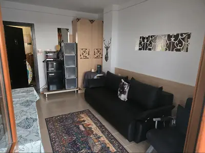 a living room with a black couch and a rug at Gardenia Hills in Sunny Beach