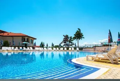 a large swimming pool with lounge chairs in a resort at Gardenia Hills in Sunny Beach