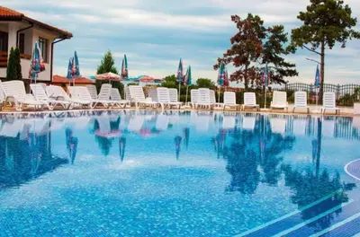 a pool with chairs and people in the water at Gardenia Hills in Sunny Beach