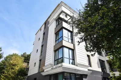 a white building with windows on the side of it at Small Central Flat - Walk to Station & Cathedral in Varna City