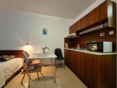 a room with a bed and a table and a microwave at complex Rose Residence Studio in Sunny Beach