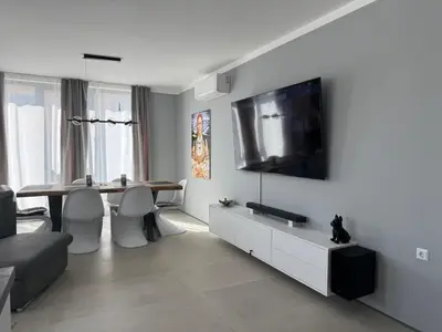 a living room with a table and a television on a wall at Apartment Victoria in Kraymorie